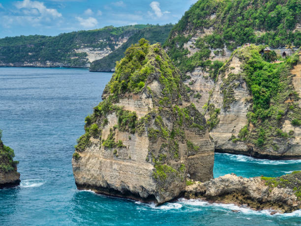 istock Atuh Beach is a Rustic, isolated cove beneath a sheer cliff face, with a sandy beach offshore rock formations. 1467320799