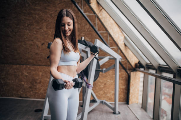 istock Woman exercising with dumbbells 1467322495