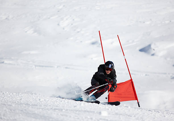 istock Ski racer near flag checkpoint coming down the slope 146732513