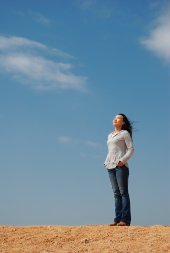 Young Woman Relaxing over blue sky