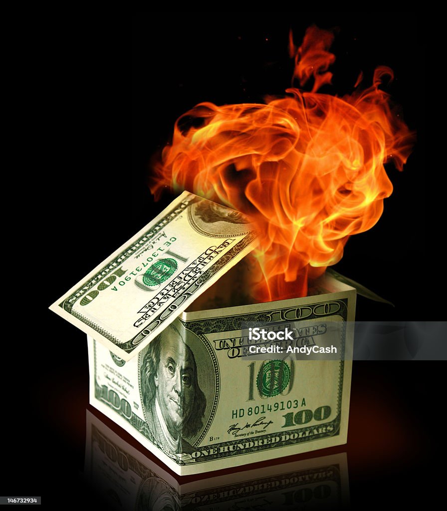 Financial crisis concept House made of USA dollar bank notes in fire Abstract Stock Photo