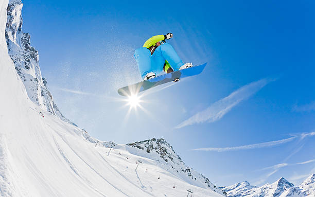 istock Backlit snowboarder soaring over snowy mountains 146732938