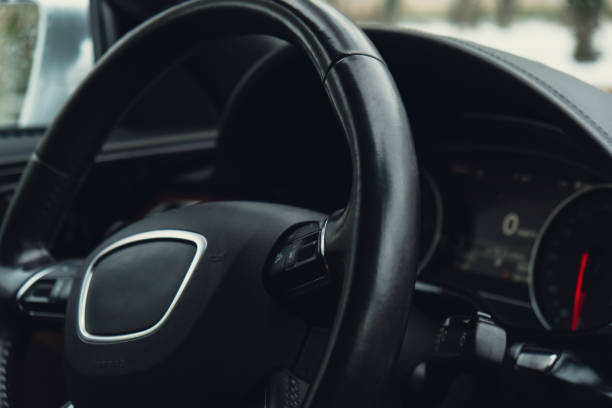 istock Black luxury modern car Interior. Steering wheel, shift lever and dashboard. Detail Automatic gear stick. Part of leather seats with stitching climate control, speedometer 1467329609
