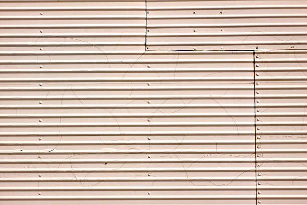 corrugated metal with rivets and white paint stock photo