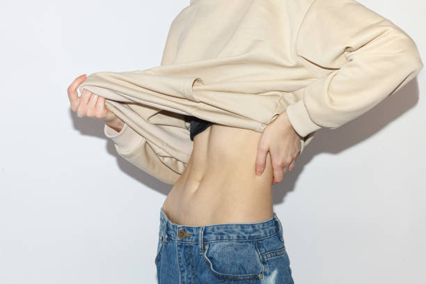 woman showing her perfect abs under oversize clothing