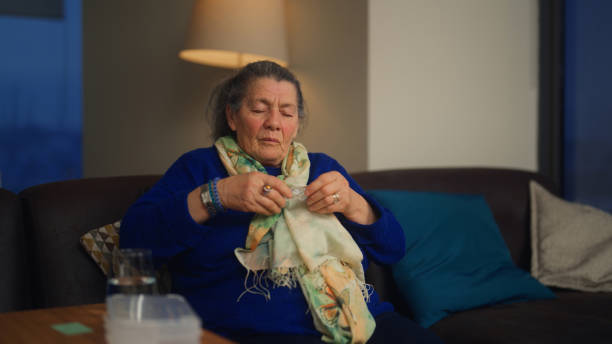 istock Senior woman feeling headache and taking painkiller 1467336734