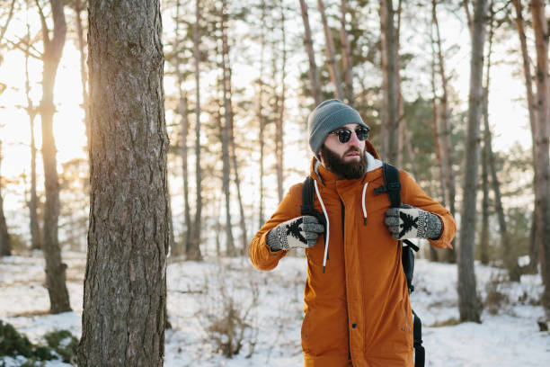 istock Hiker male walking with backpack in snowy winter forest 1467341789