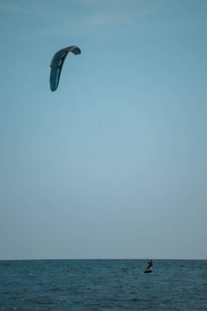 istock Kitesurfing riding over a surface of the sea 1467341986