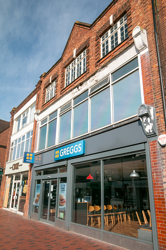 People in the background of Greggs Bakery on Tonbridge High Street in Kent, England