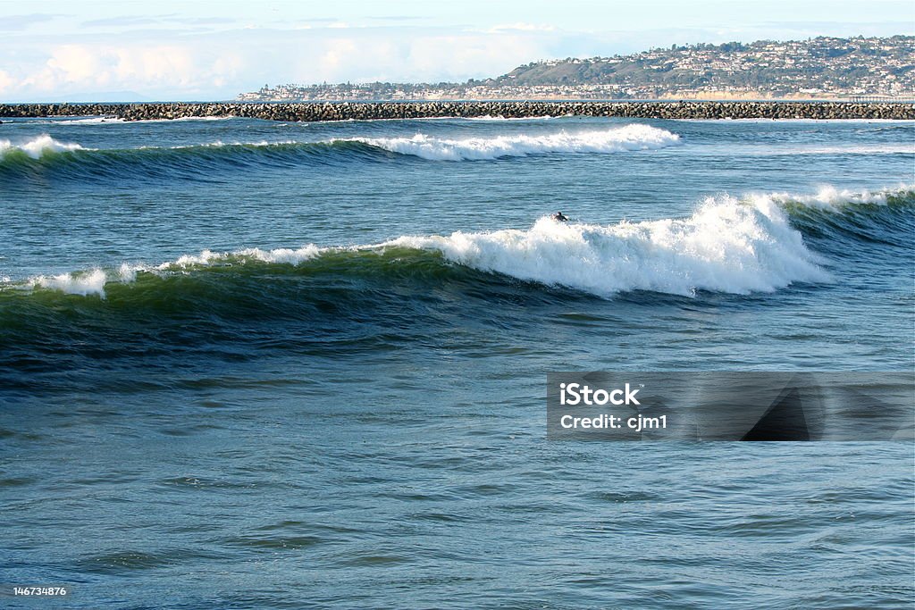 Wave Set a set of waves at ocean beach pier with the jetty and mission beach in the background. Beach Stock Photo