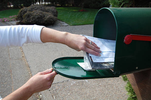 A picture of someone getting their mail stock photo