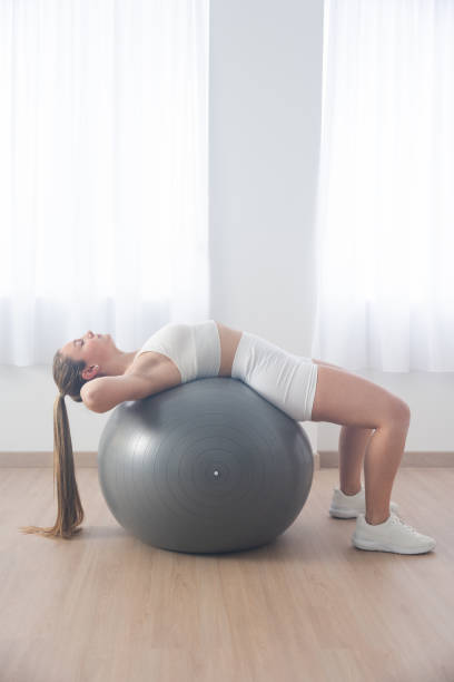istock Young woman stretching at home with copy space 1467352583