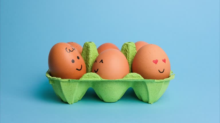 Cute easter eggs with funny faces in green box isolated on blue background. Happy easter concept. Stop motion easter animation