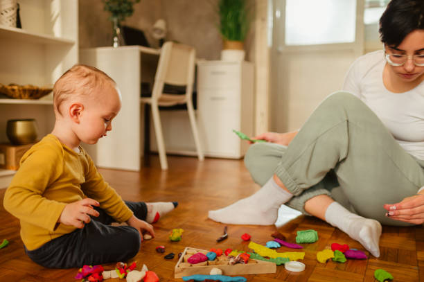 istock Mother and son playing with clay at home and creating art 1467358327