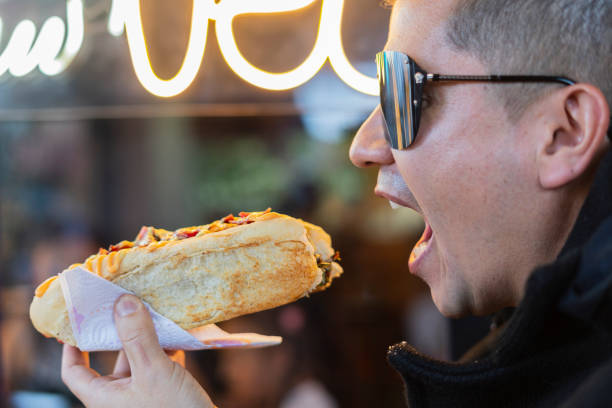 A man Eating Hot Dog Sausages