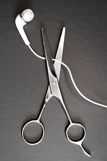 istock a of scissors and earphone on a black table 1467361129