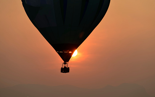 A balloon silhouette with sunset in background