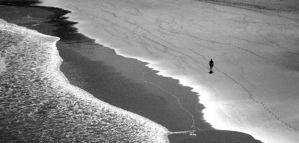 Beach seen from viewpoint, in A Coruña  province, Galicia, Spain. Unrecognizable person walking.