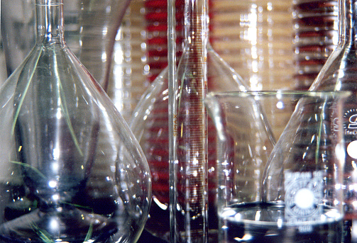 Laboratory research, close-up view of laboratory glass bottles and display of petri dishes .