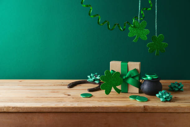 istock St Patrick's day concept with shamrock decorations and gift box on wooden table over green background. 1467365582