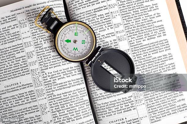 Compass On Bible Stock Photo - Download Image Now - Bible, Navigational Compass, Arrow Symbol