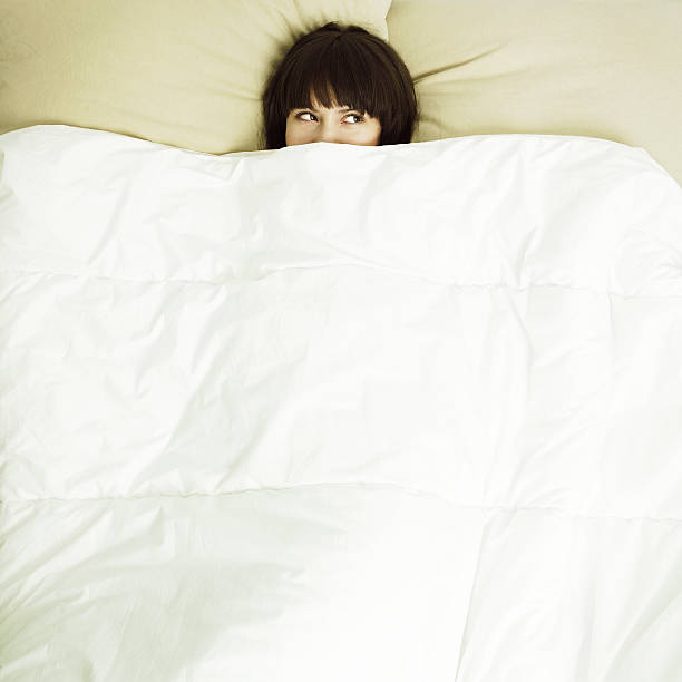 istock Young beautiful woman in bed under a white coverlet 146736679