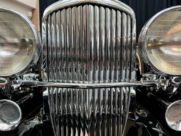 Closeup from the chrome grille and exhaust system on an old, restored Duesenberg automobile from the early 1900s.