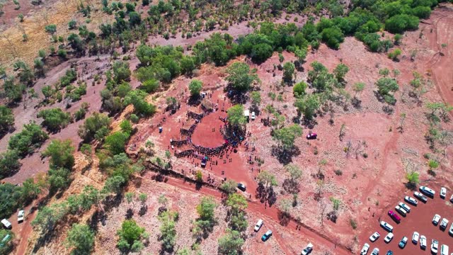 Circling aerial view of the cermony at the start of the Freedom Day Festival at Kalkaringi, Northern Territory, Australia. 26 August 2022.