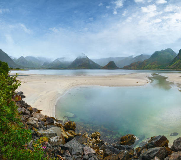istock Norwegian Sea cloudy night view with sandy beach (not far Vagan, Norway). 1467371837