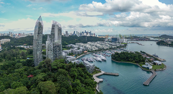 The Keppel Bay area in Singapore is a modern, luxury residential district full of skyscrapers, big yachts in the marina and tropical rainforest.