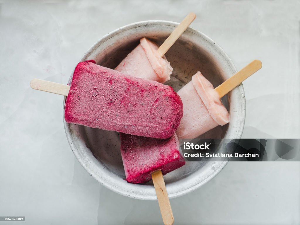 Homemade, bright ice cream on the table Homemade, bright ice cream on the table. Close-up, view from above. Tasty and healthy eating concept Flavored Ice Stock Photo