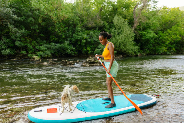 istock Woman and her pet on standup paddleboard 1467375547