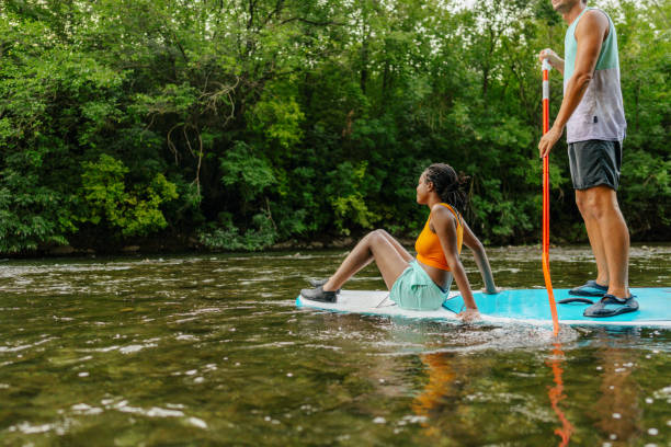 istock Multiracial couple riding a SUP paddleboard together 1467375608