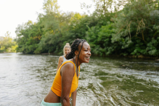 istock Female friends spending summer day by the river 1467375615