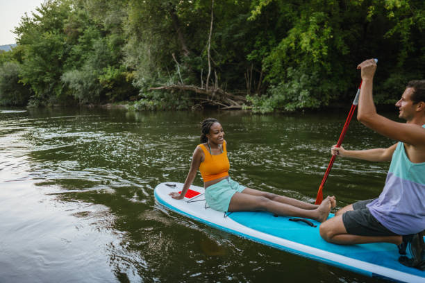 istock Multiracial couple riding a SUP paddleboard together 1467375617