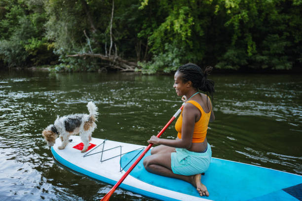 istock Woman and her pet on standup paddleboard 1467375619