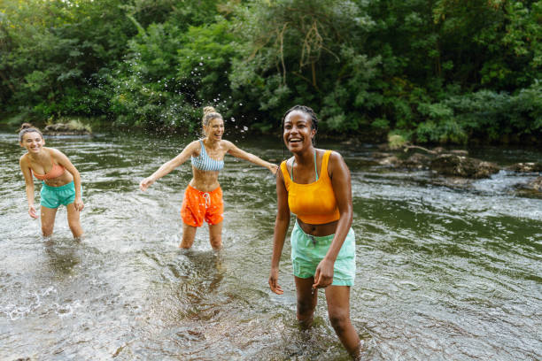 istock Female friends spending summer day by the river 1467375637