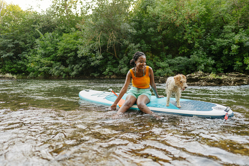 Woman and her pet on standup paddleboard