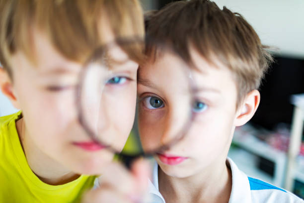 Two boys looking at camera thought loupe