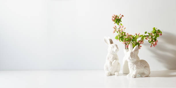 istock Spring flowers in a vase and easter bunny on a light background. Easter background with copy space 1467375912