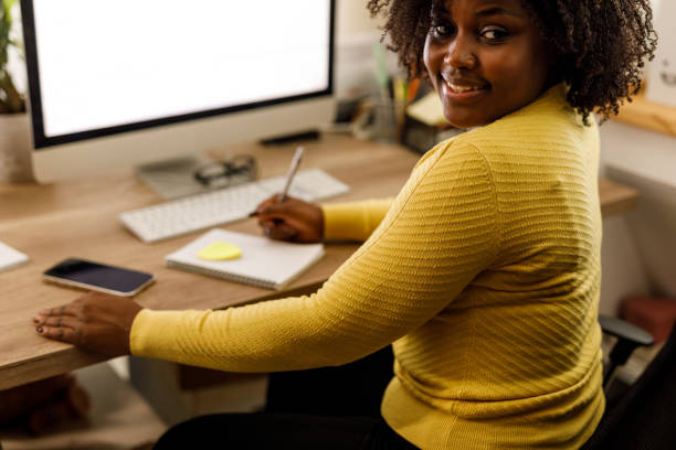 istock Young woman looking over shoulder and smiling as if someone called her name 1467376303
