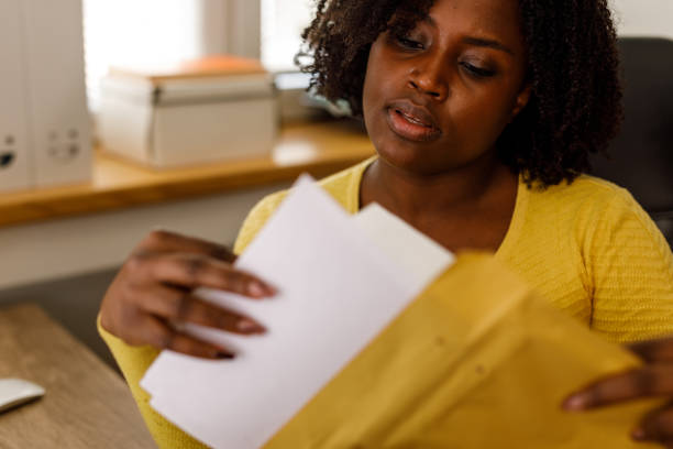 surprised woman gets letter with bad news