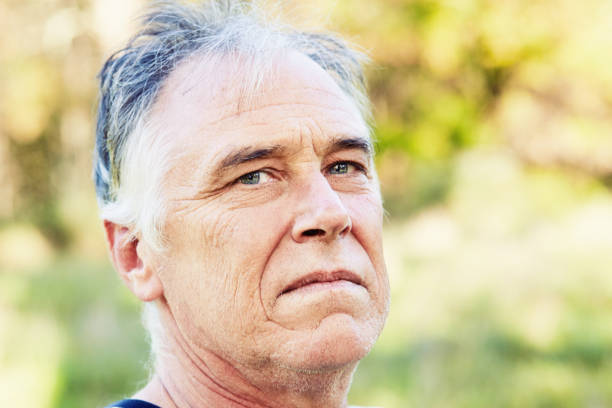 istock Handsome mature man looks sternly at the camera while standing outdoors on a sunny day 1467377884