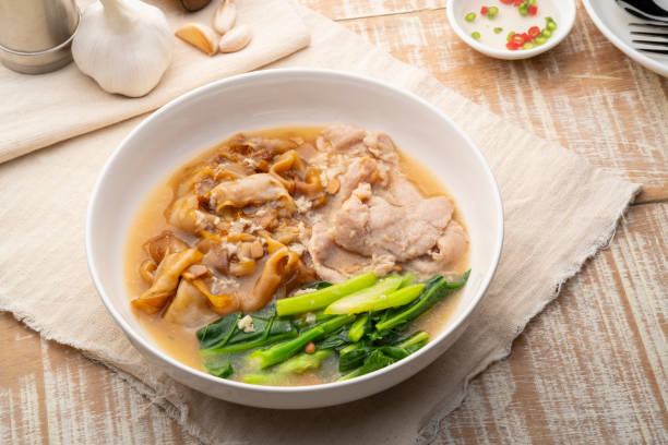 istock Flat Noodles with Marinated Pork and Collard greens in Gravy Sauce 1467378429