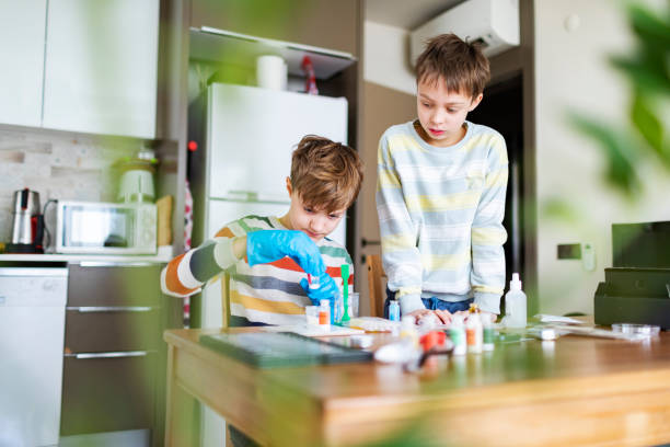 istock Two boys making science chemical experiment at home 1467380085