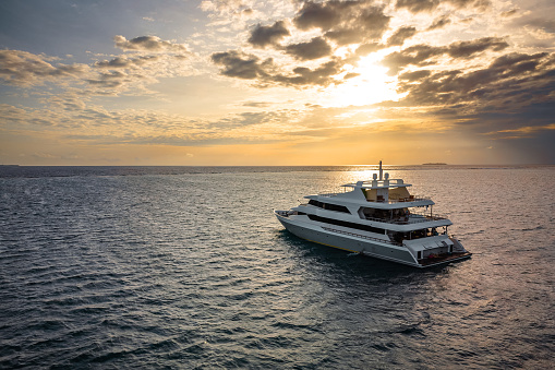 Luxury yacht in the open sea at sunset