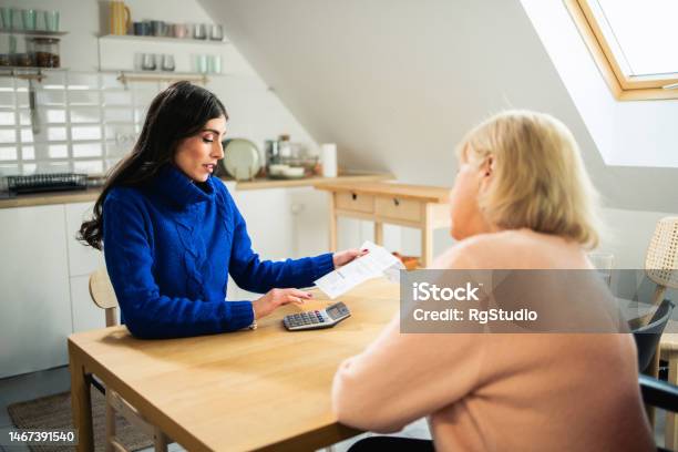 Volunteer Helps An Elderly Person With Daily Activities Stock Photo - Download Image Now