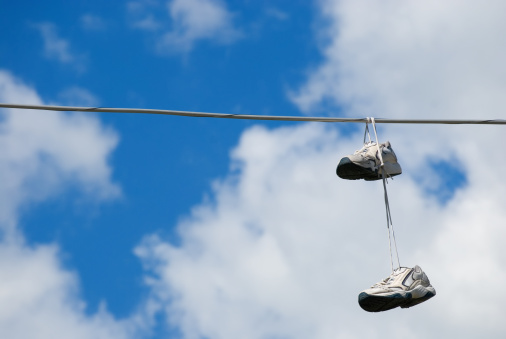 Pair of sneakers hanging from power line