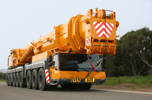 Mobile crane, 500 tonne all-terrain Liebherr LTM 1500-8.1. Orange and black in colour. View from front-right. 16 Wheels, 8 axles.