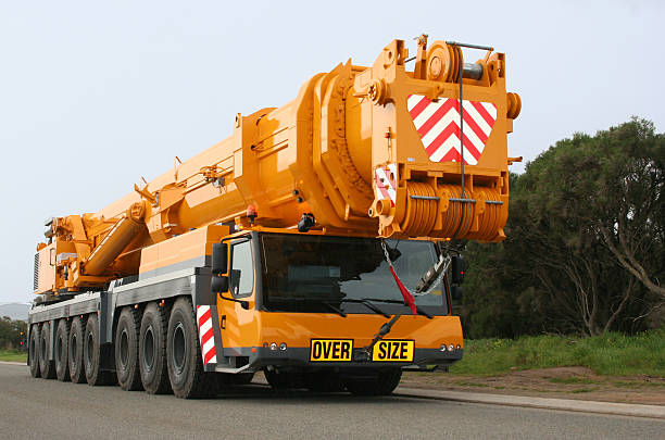 Mobile crane, 500 tonne all-terrain Liebherr LTM 1500-8.1 Mobile crane, 500 tonne all-terrain Liebherr LTM 1500-8.1. Orange and black in colour. View from front-right. 16 Wheels, 8 axles. crane machinery photos stock pictures, royalty-free photos & images